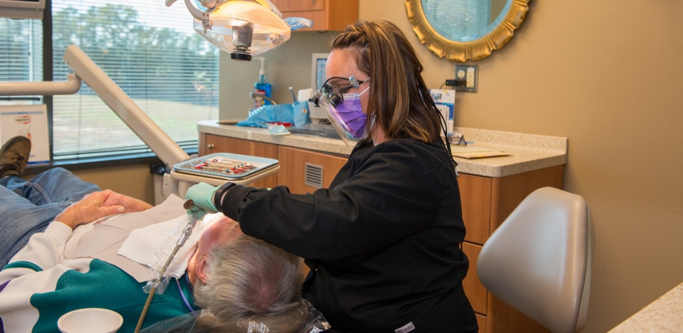 Dentist performing root canal treatment in Buckhead Atlanta on a dental patient