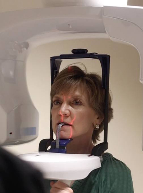 Woman receiving a dental scan of her mouth and jaw
