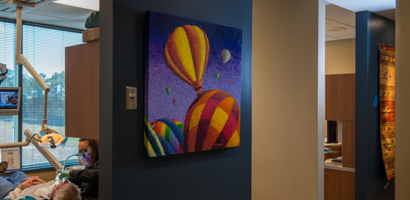 Colorful painting of hot air balloons on wall of dental office