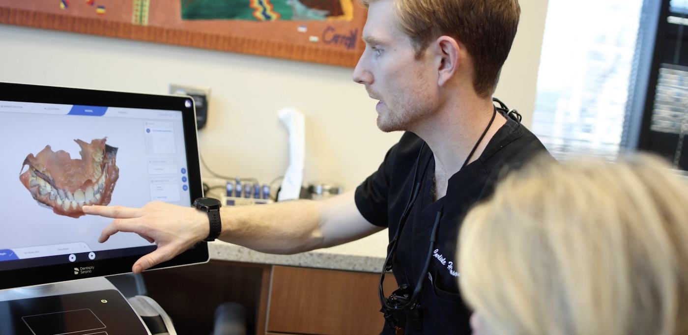 Cosmetic dentist in Buckhead Atlanta showing a patient digital images of their teeth on computer screen