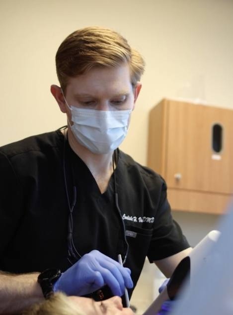 Doctor Vason examining the mouth of a dental patient