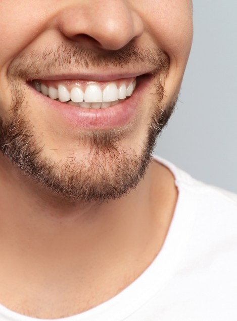 Close up of man with short facial hair smiling