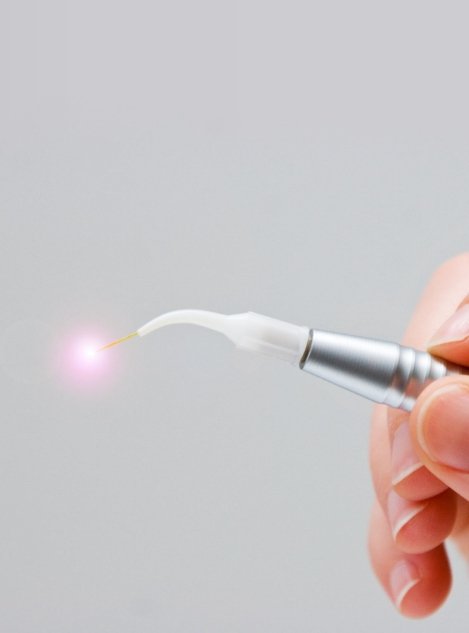 Person holding dental soft tissue laser in their hand