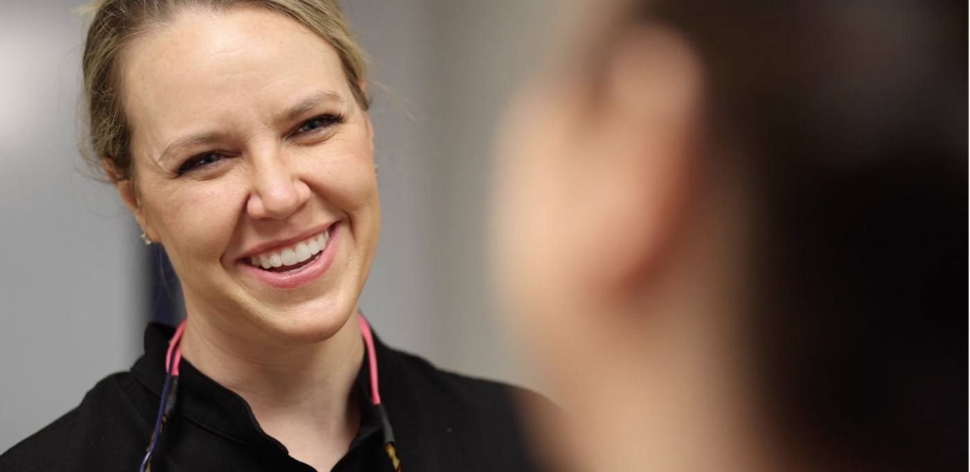 Doctor Grisham smiling at a dental patient in Buckhead Atlanta