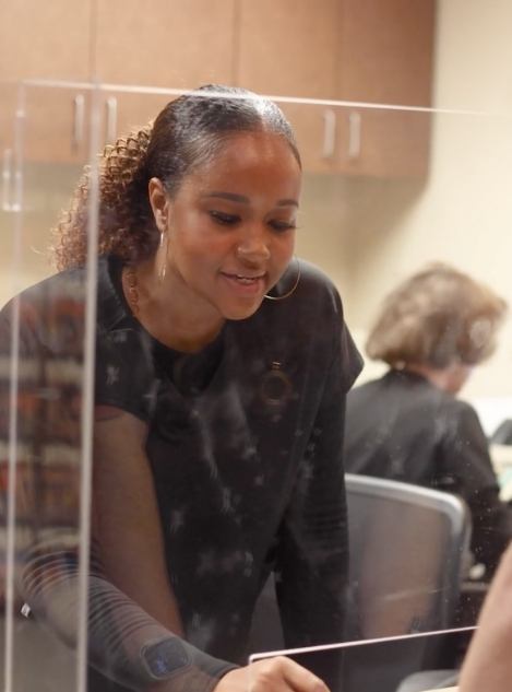 Dental team member helping a patient at front desk