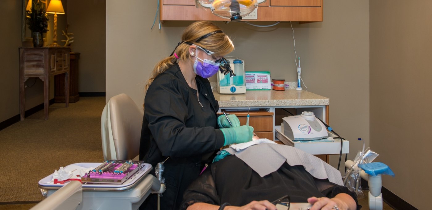 Dentist examining a patient before full mouth reconstruction in Buckhead Atlanta