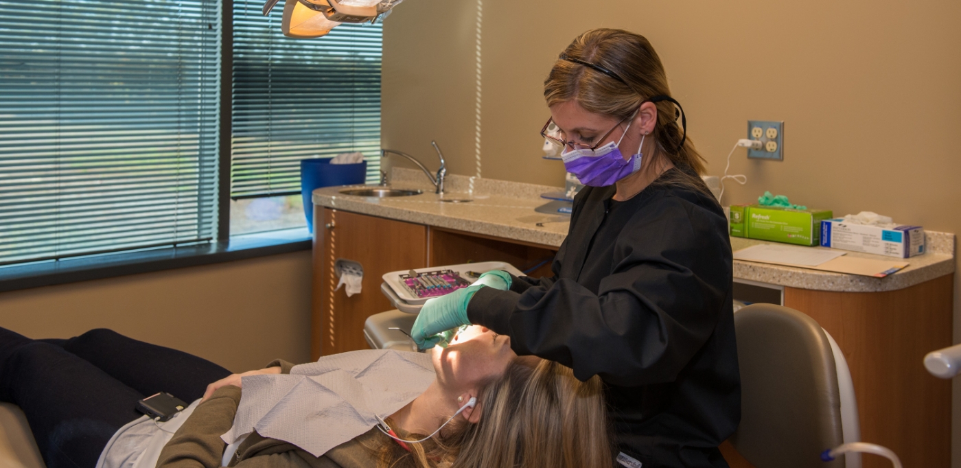 Woman receiving gum disease treatment in Atlanta from her dentist