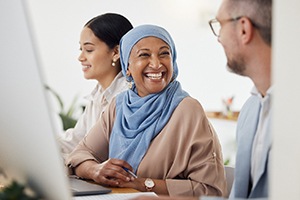 Woman smiling at colleague in office