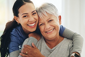 Two women smiling while hugging