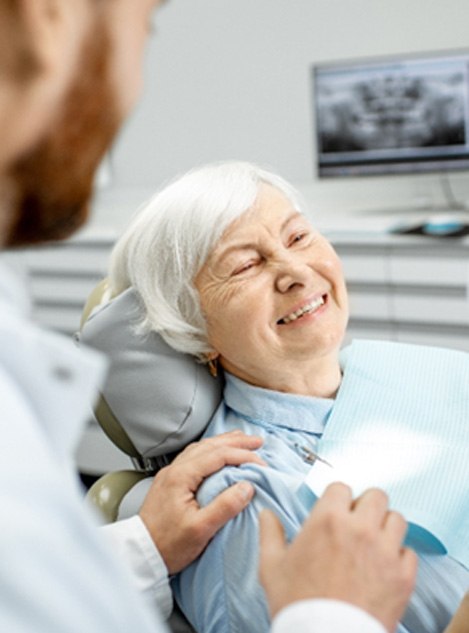 A happy elderly woman enjoying her new dental implants