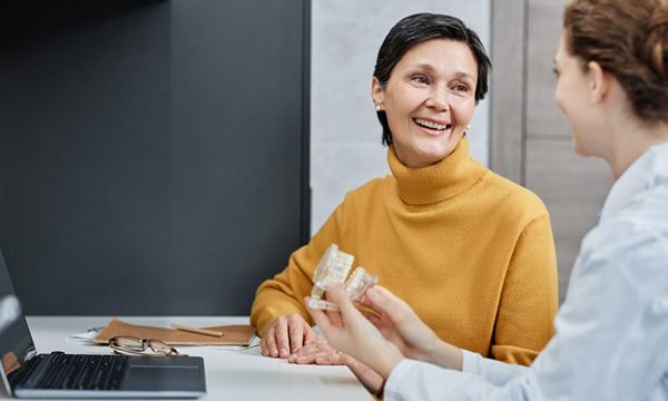 a patient discussing dental implants with her dentist