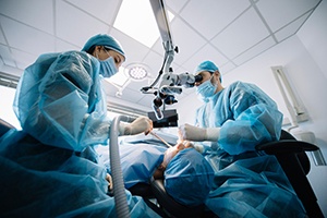 A team of dentists finishing a dental implant surgery