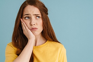 A woman experiencing a slight ache in her mouth