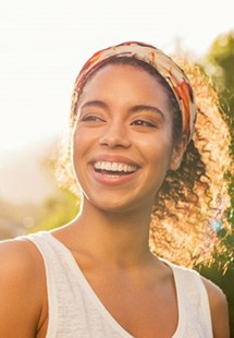 woman smiling after replacing a missing tooth