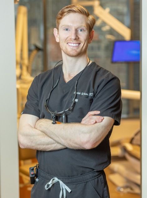 Doctor Carlisle Vason smiling while standing with his arms crossed