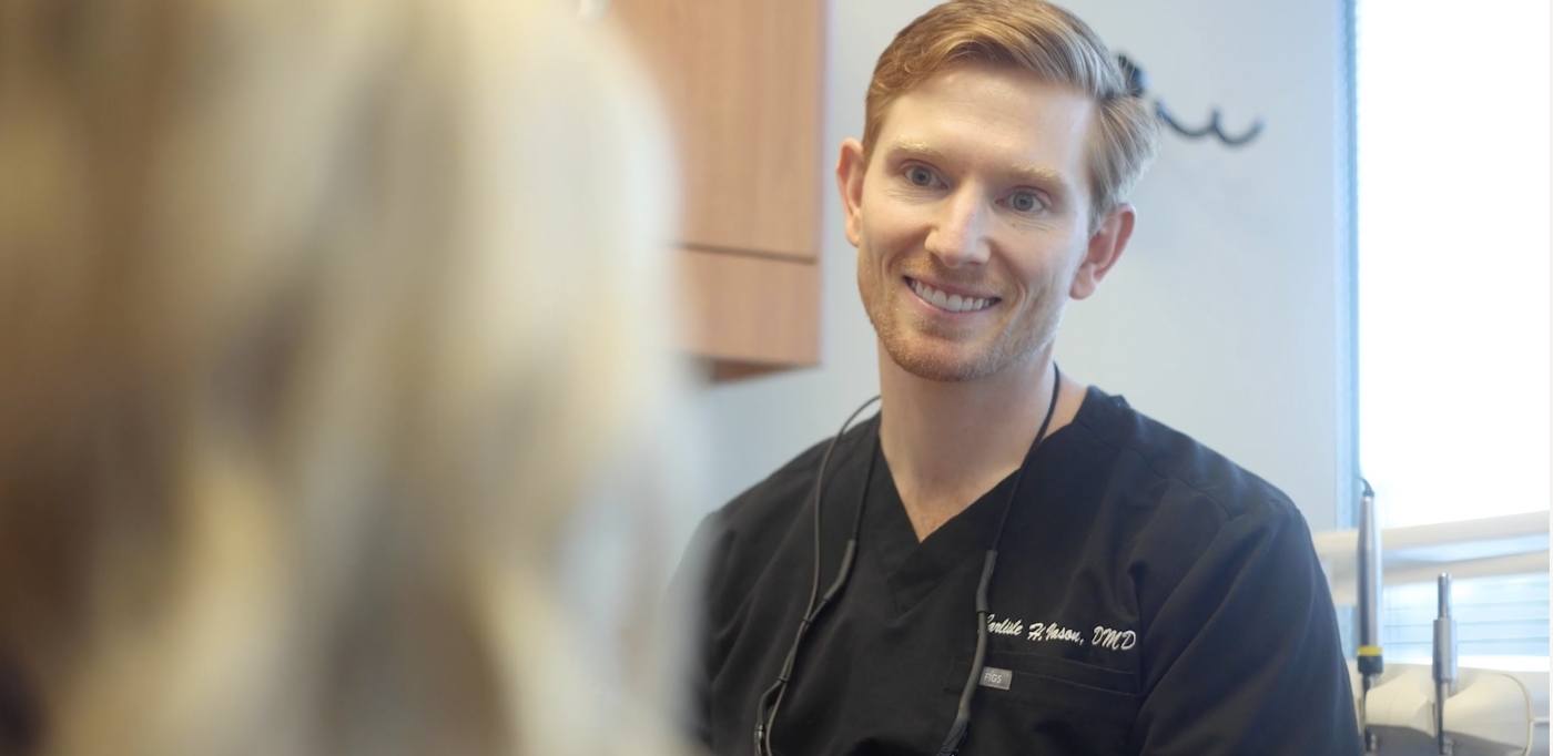 Doctor Carlisle Vason smiling at a dental patient in Atlanta