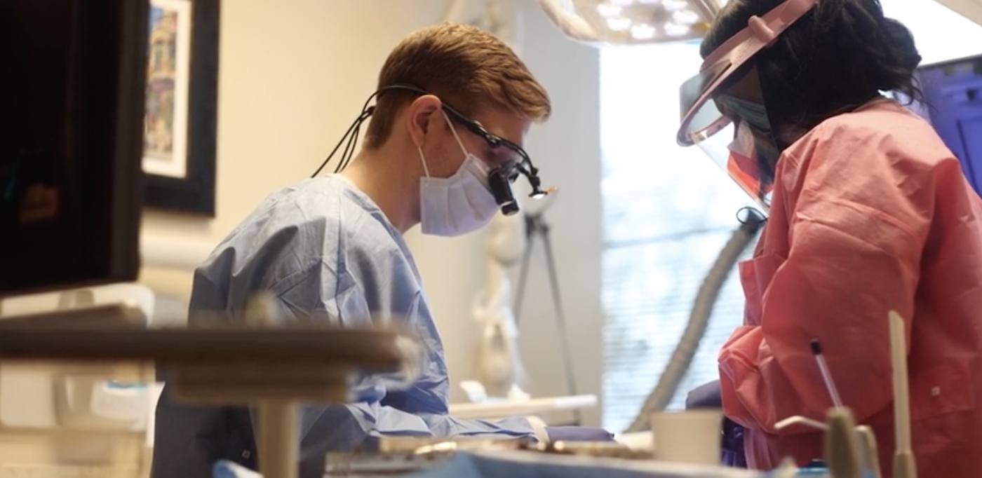 Dentist and team member providing dental services in Atlanta to a patient