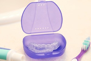 Clear aligner in a purple case