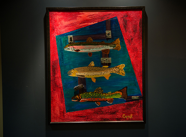 Painting of three fish with a red background