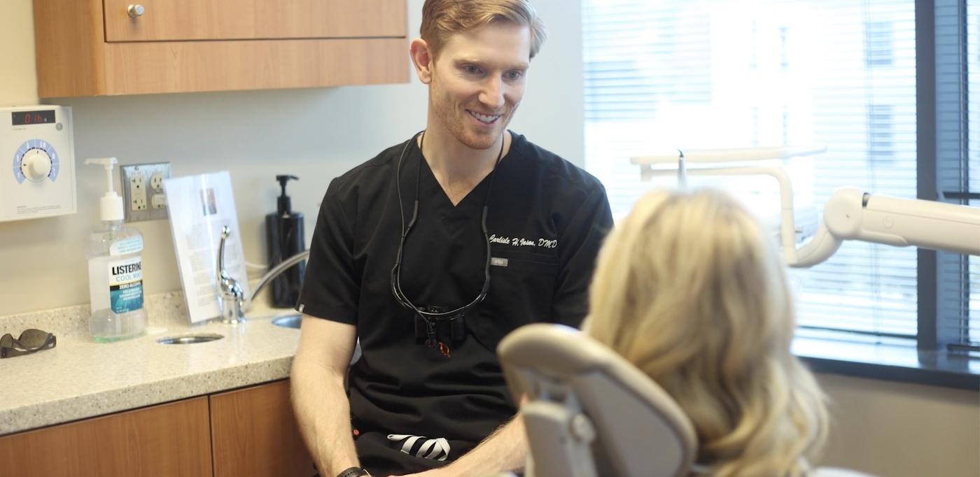Dentist speaking to a female patient