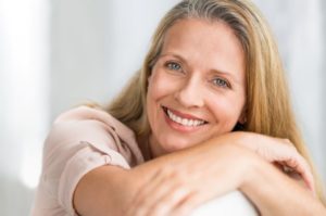 Attractive, mature woman smiling after full mouth reconstruction in Atlanta