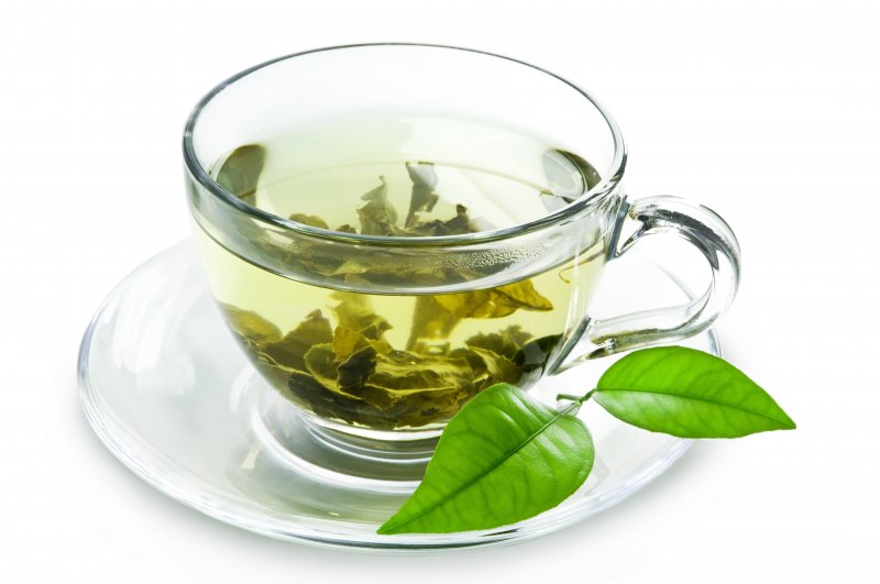 a mug of green tea lying on a table