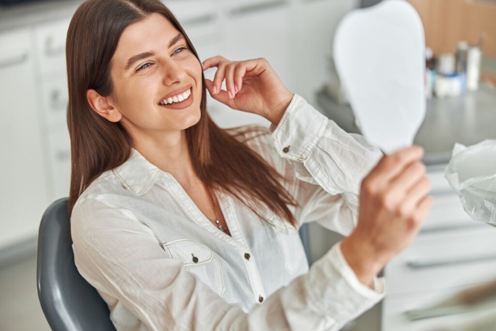 A woman smiling in a dental chair