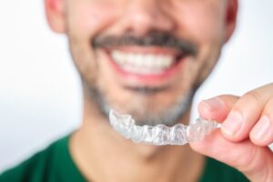 Man putting on his clear aligners