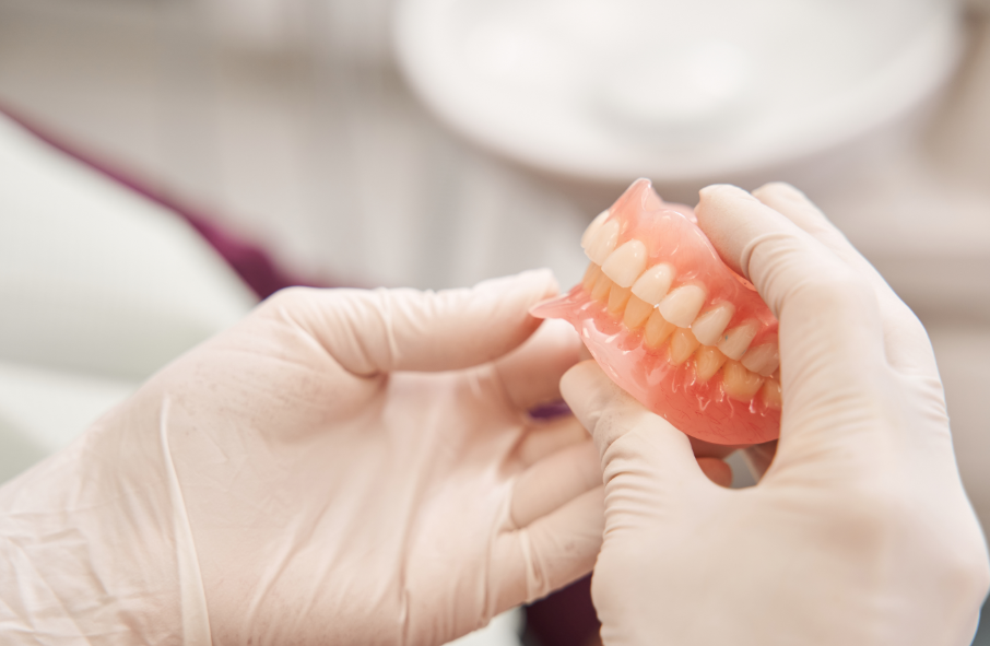 Dentist holding dentures